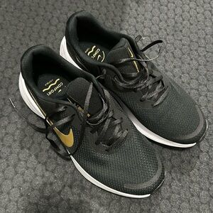 Black and gold Nike shoes